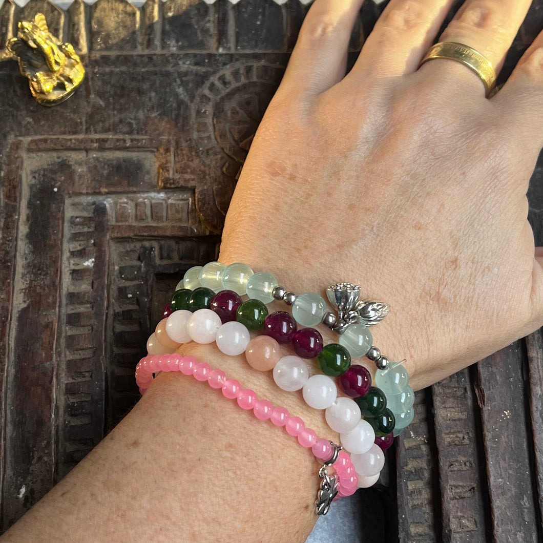 Stack of 4 natural crystal gemstone stacking bracelets with clover & lotus seed/flower charms